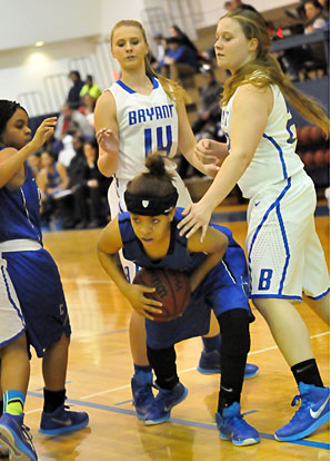 Bryant's Riley Hill (14) and Anna Turpin defend as a Conway player tries to escape. (Photo by Kevin Nagle)