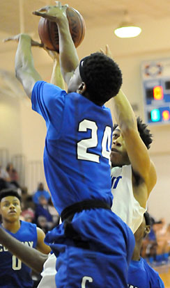 Rickie Allen meets Conway's Tyler Smith (24) on the way to the hoop. (Photo by Kevin Nagle)