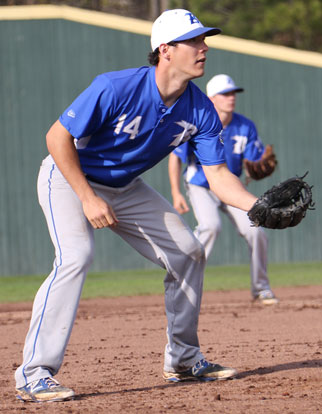 Third baseman Brandan Warner and shortstop Jake East, background, set up defensively during the first game of Friday night's conference doubleheader. (Photo by Rick Nation)