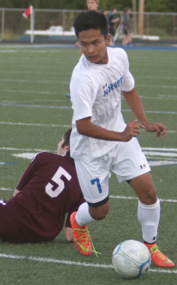 Krisha Gurung (7) dribbles past a Benton defender. (Photo by Rick Nation)