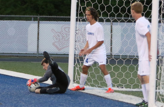 Bryant goalkeeper Hayden Ray makes a save as Connor Qualls (4) and Chris Godwin. (Photo by Rick Nation)