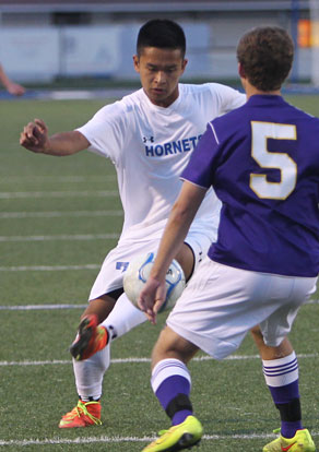 Krishna Gurung tries to maneuver around a Catholic player. (Photo by Rick Nation)