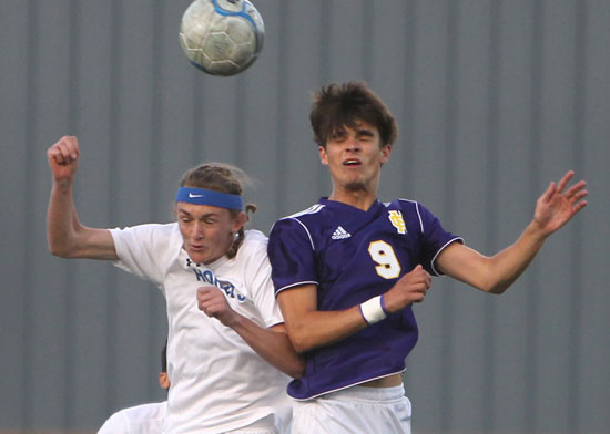 Logan Moore, left, goes up for a contested header. (Photo by Rick Nation)