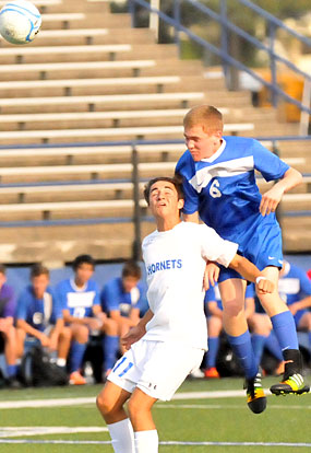 Bryant's Dylan Wolf, left, tries to defend against a Conway header. (Photo by Kevin Nagle)