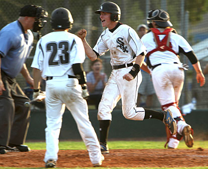 Seth Tucker celebrates his game-winning steal of home Benton catcher Cody Icenhower chases an errant pitch in the first game of Thursday's doubleheader. (Photo by Rick Nation)