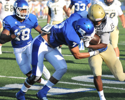 Jaelyn Jones (7) hits Tre Bruce (15) as Mavin Moody (18) arrives to help out. (Photo by Kevin Nagle)