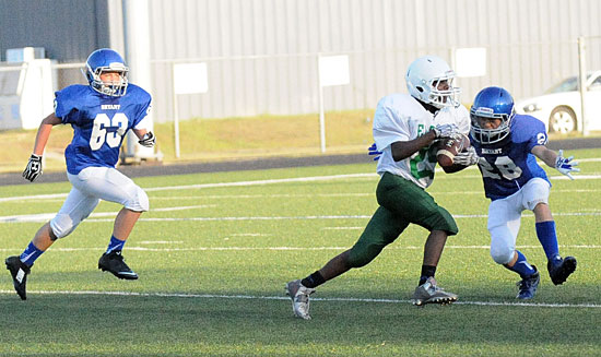 Bryant White's Damien Constanino (28) draws a bead on Forest Heights' Jarmall Lovelace as Harrison Woodham (63) hustles to help out. (Photo by Kevin Nagle)