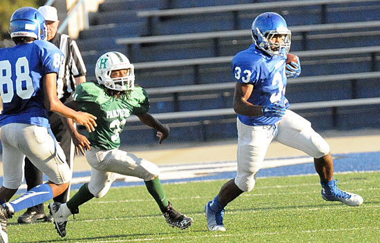 Running back Ahmad Adams (33) turns the corner on a sweep. (Photo by Kevin Nagle)