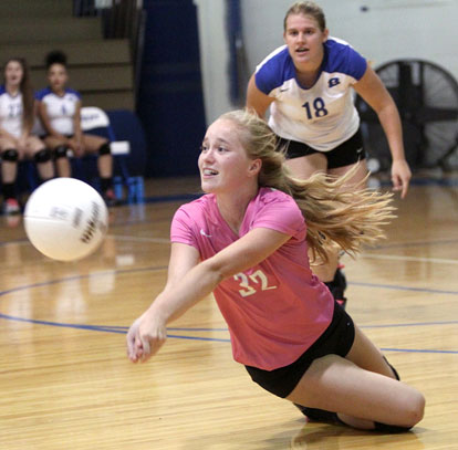 Whitney Brown digs up a Van Buren hit as teammate Kaci Squires backs her up. (Photo by Rick Nation)