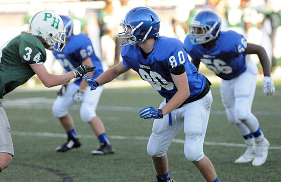 Brantley Thomas (80), Andrew Bailey (56) and Harrison Woodham (63) set up defensively for the Bryant White Hornets Tuesday. (Photo by Kevin Nagle)