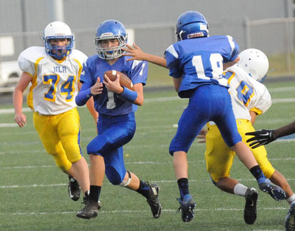 Jake Meaders (1) splits a pair of defenders with a little help from teammate Ethan Loomis (18). (Photo by Kevin Nagle)