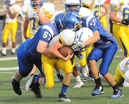 Bethel's Tanner Wilson (67) and Ryan Riedmueller (15) make a tackle. (Photo by Kevin Nagle)