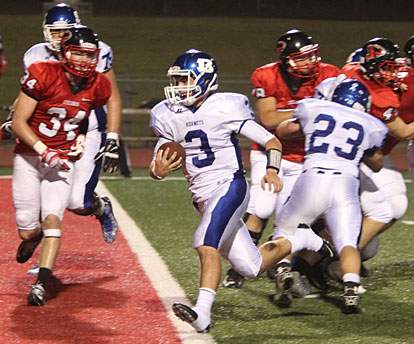 Gunnar Burks scores standing up off a block from Drew Alpe (23). (Photo by Rick Nation)