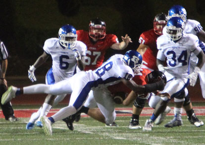 Marvin Moody (18) makes a tackle as Gregg Williams (34), Phillip Isom-Green (6) and Cameron Murray arrive to help. (Photo by Rick Nation)