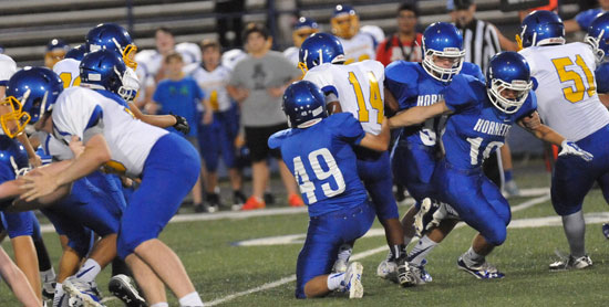 Ryan Lessenberry (49) makes a tackle during Tuesday night's game. (Photo by Kevin Nagle)