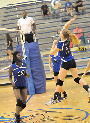 Kristin Boyle (13) watches as teammate Meagan Chism attacks. (Photo by Kevin Nagle)