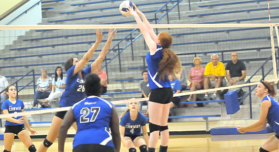 Faith Stone goes high to make a block. (Photo by Kevin Nagle)