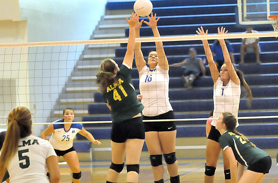 Brittney Warner (16) and Shaelyn Smith (7) go up for a block in front of teammate Ashlyn Lee (25). (Photo by Kevin Nagle)