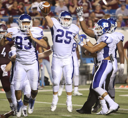 Devon Alpe (25) shows the fumble he recovered. (Photo by Rick Nation)