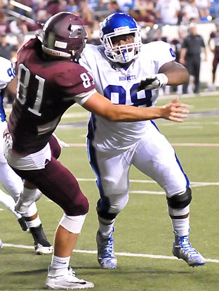 Cameron Murray bowls over Benton blocker Jeremiah Bowling (81). (Photo by Kevin Nagle)