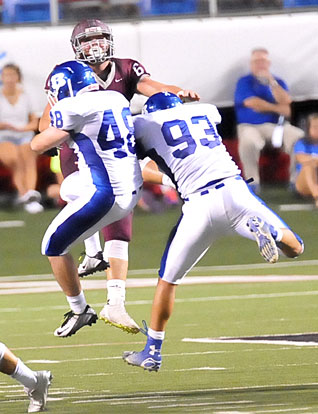 Peyton Robertson (48) and Madre Dixon (93) block Roy Blaylock's punt. (Photo by Kevin Nagle)