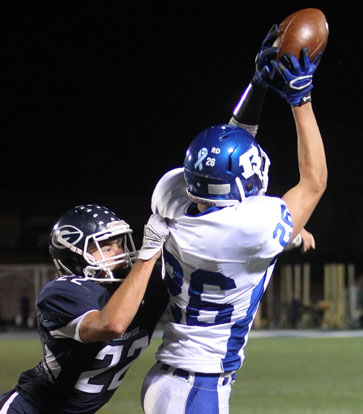 Landon Smith (26) goes high for one of his three receptions in Friday's game. (Photo by Rick Nation)