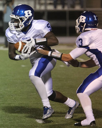 Quarterback Gunnar Burks hands off to running back DeAmonte Terry. (Photo by Rick Nation)