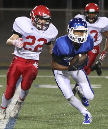 Andrew Hayes hauls in a pass in front of Cabot Red's Zhane Harper. (Photo by Rick Nation)