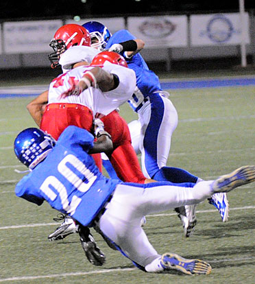 K.J. Terry (20) hauls down Cabot Red's Tadariyan Rogers. (Photo by Kevin Nagle)