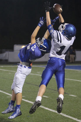 Aaron Morgan (83) contests a pass to Conway White's Parker Prock (14). (Photo by Rick Nation)