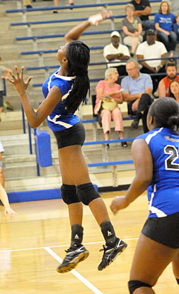 Kristin Boyle goes high for a hit. (Photo by Kevin Nagle)