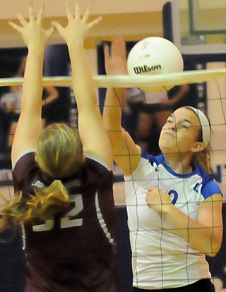 Kendall Selig (9) contends at the net. (Photo by Kevin Nagle)