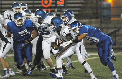 Logan Grant (10) latches onto Conway White quarterback Jovoni Johnson. (Photo by Kevin Nagle)