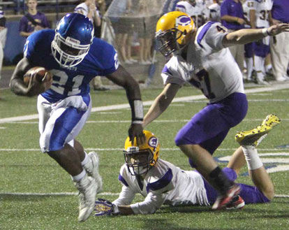 Cameron Coleman (21) barrels into the end zone after running over Catholic's Jared Allison and past Ethan Southward (47). (Photo by Rick Nation)