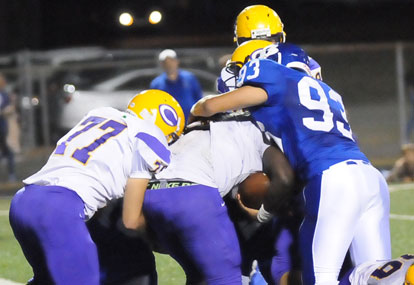 Bryant's Madre Dixon (93) grabs Catholic running back Lance Harville-Thomas in the end zone for a safety. (Photo by Kevin Nagle)