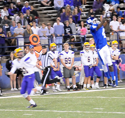 Quentin Royal (4) goes high for an interception in front of Catholic's Preston Wilson (81). (Photo by Kevin Nagle)