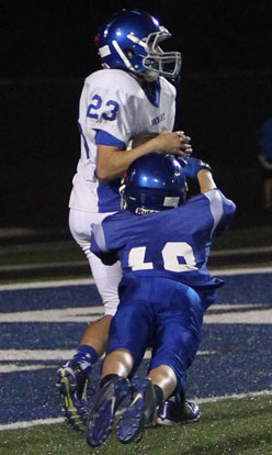 Drake Findley catches a pass for a two-point conversion despite the efforts of Ethan Loomis (18). (Photo by Rick Nation)