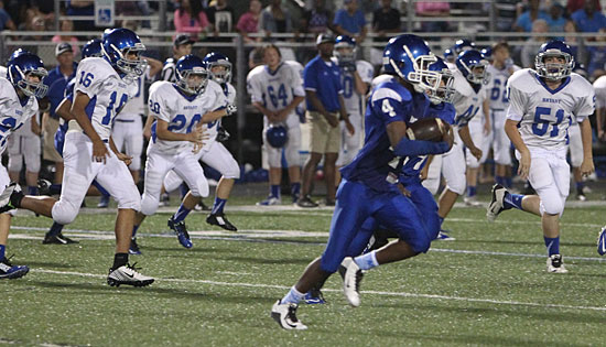 Bryant Blue's Christian Cain (4) heads upfield on his 72-yard kickoff return pursued by Bryant White's Maliki Griffin (16), jonathan Ray (20) and Luke Staton (51). (Photo by Rick Nation)