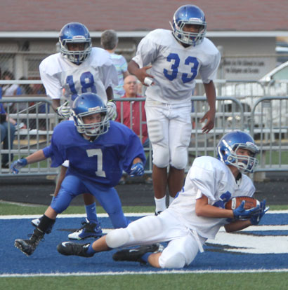 Bryant White's Austin Ledbetter goes to the ground to make a catch in front of Bryant Blue's Ryan Riggs (7) along with teammates Dalen Holman (18) and Conner Coleman (33). (Photo by Rick Nation)