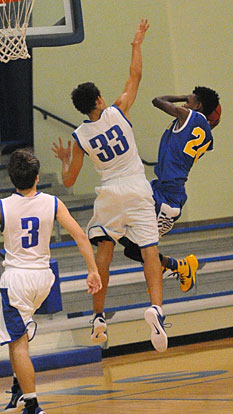 Alex Blair (33) goes up for a block. (Photo by Kevin Nagle)