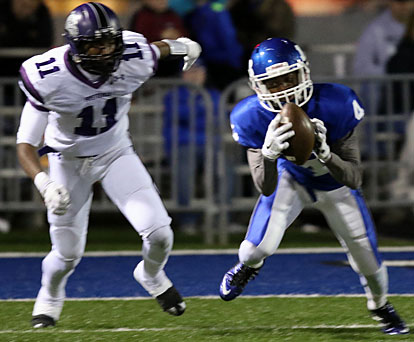 Bryant cornerback Quinton Royal (4) makes an interception in front of Fayetteville receiver Tyson Morris. (Photo by Rick Nation)