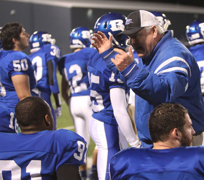Defensive line coach Brad Stroud instructs on the sideline. (Photo by Rick Nation)