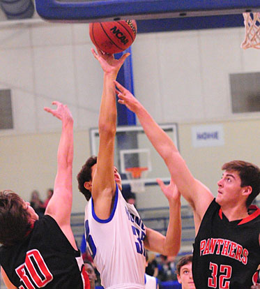 Bryant's Alex Blair shoots over Cabot White's Keith Ray (32). (Photo by Kevin Nagle)