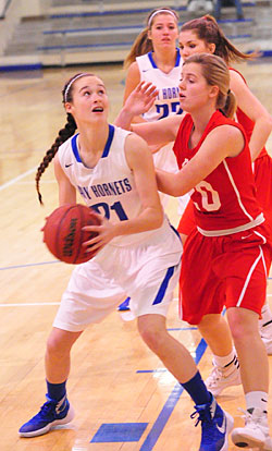 Mary Catherine Selig (21) looks for room to get a shot away as teammate Lauren Burnett tries to get around a Cabot North defender. (Photo by Kevin Nagle)