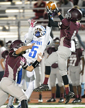 Benton's Peyton Pallette goes over Bryant's Jaylon Dickson (5) for an interception early in Tuesday's game. (Photo by Kevin Nagle)