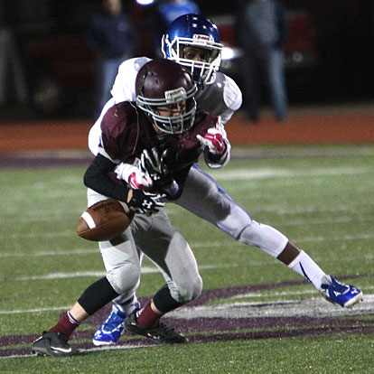 Bryant's Andrew Hayes knocks the ball loose from Benton receiver Bradyn Hendrix. (Photo by Rick Nation)