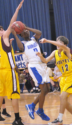 Rodney Lambert (2) splits a pair of Lake Hamilton defenders pulling up off a drive. (Photo by Kevin Nagle)