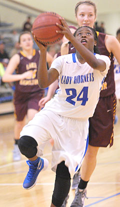 Kali Walker (24) drives to the basket. (Photo by Kevin Nagle)