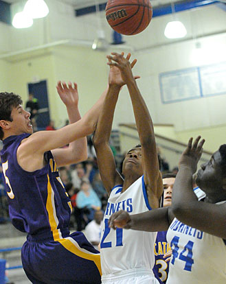 Bryant's Josh Robinson (21) releases a shot in a crowd as teammate KaJuan Robinson (44) gets into position for a rebound. (Photo by Kevin Nagle)