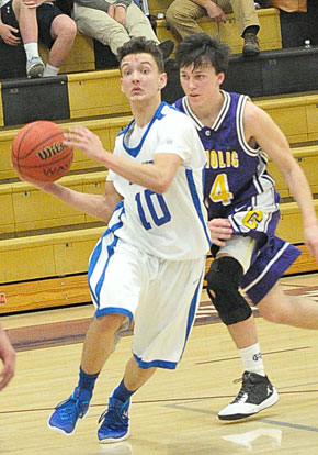 Garrett Coward (10) works around Catholic's Chad Wharton. (Photo by Kevin Nagle)